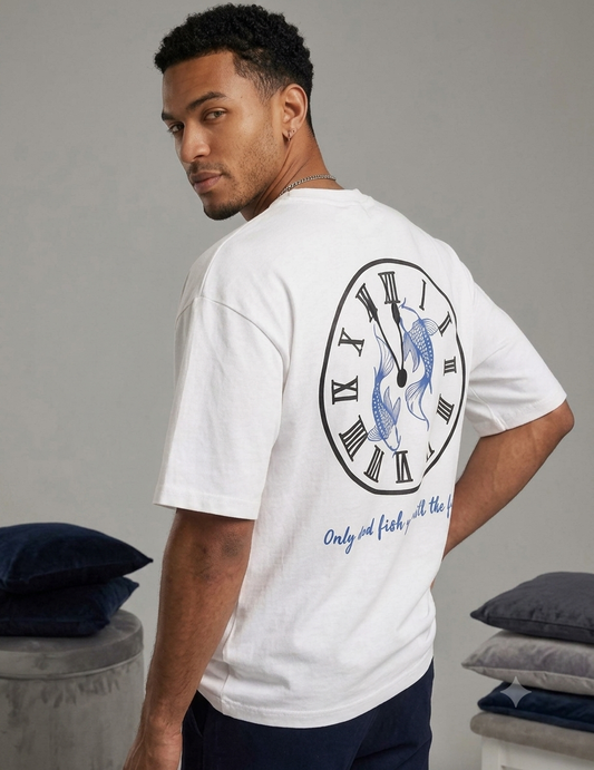 Back view of a white T-shirt featuring a circular clock with Roman numerals, two koi fish inside the clock, and the text “Only dead fish go with the flow.
